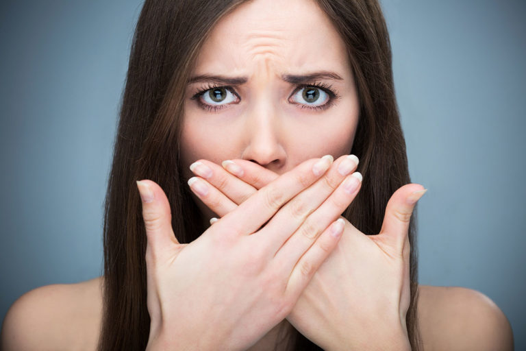 A woman covering her mouth with her hands